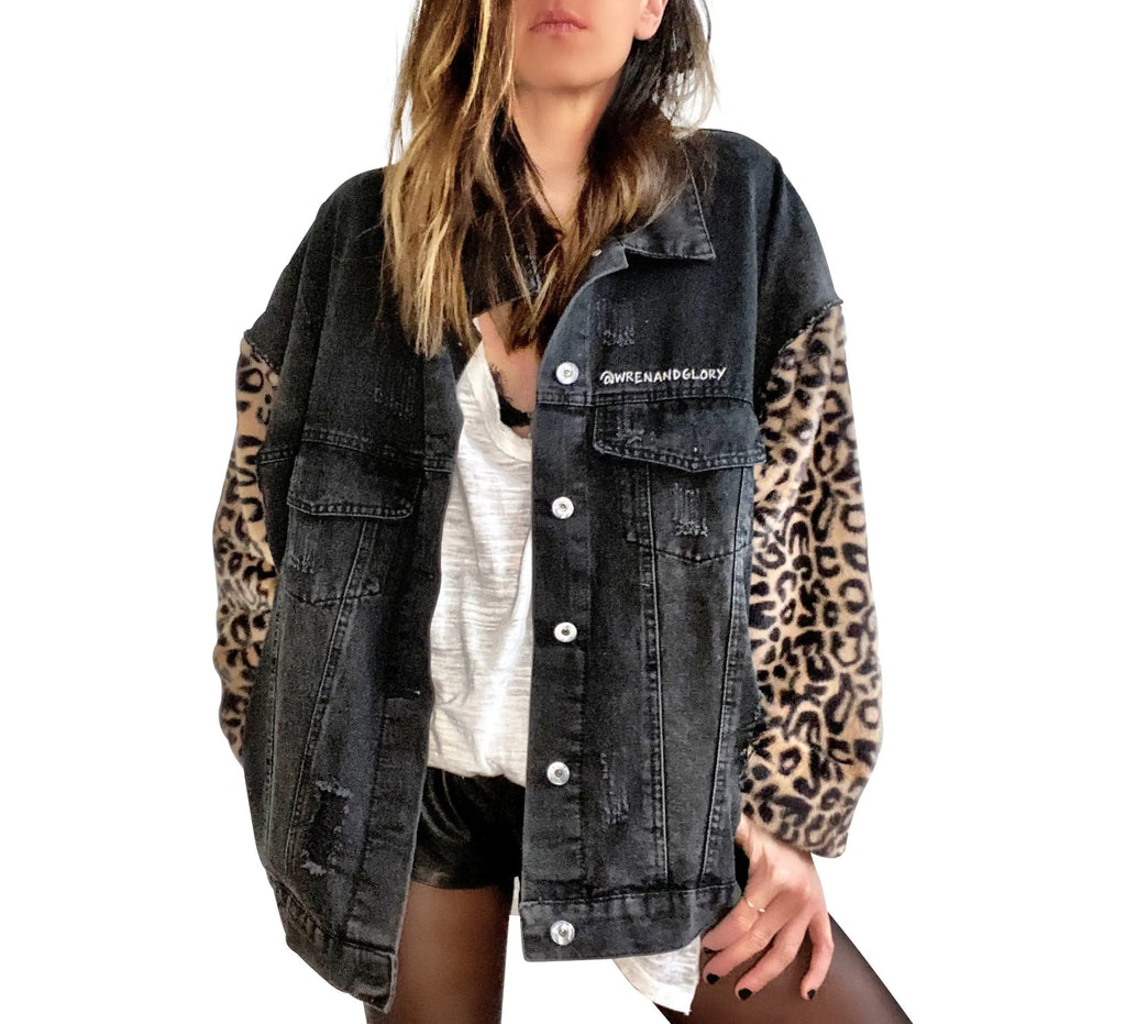 Black denim jacket with super comfortable leopard pattern sleeves. Large white cassette tape painted on back, with white flowers and leaves sprouting out. Signed @wrenandglory.