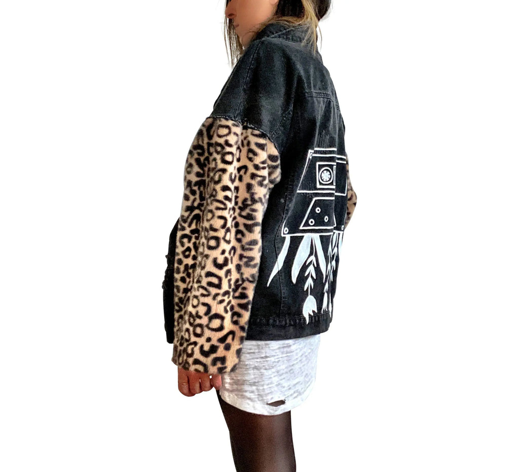 Black denim jacket with super comfortable leopard pattern sleeves. Large white cassette tape painted on back, with white flowers and leaves sprouting out. Signed @wrenandglory.