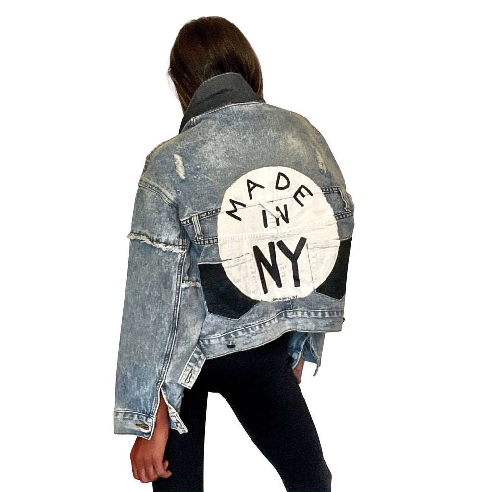 Lighter blue denim wash. White circle, painted MADE IN NYC inside in black.  Pockets and hems painted black Signed @wrenandglory.
